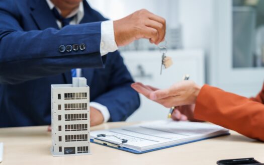 lavinia properties businessman desk in a sales office sells a condo building customer.They agree to sign a contract