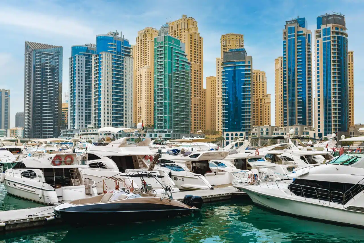 Dubai Marina waterfront apartment buildings at sunset showing prime short term rental locations with high tourist demand