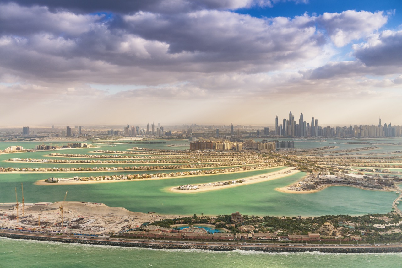 Aerial view of Palm Jumeirah luxury apartments and villas representing premium Dubai holiday home investment locations with strong tourist demand